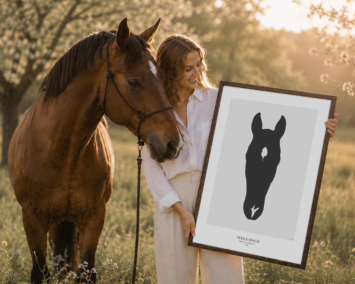 Woman holding a framed horse portrait in a field with a horse standing beside her.
